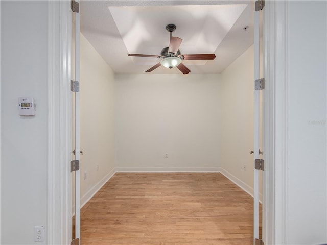 empty room featuring ceiling fan and light hardwood / wood-style floors