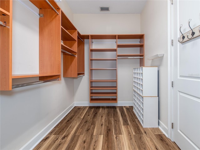 walk in closet featuring dark hardwood / wood-style flooring