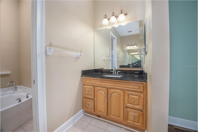 bathroom featuring vanity, tile patterned floors, and a tub