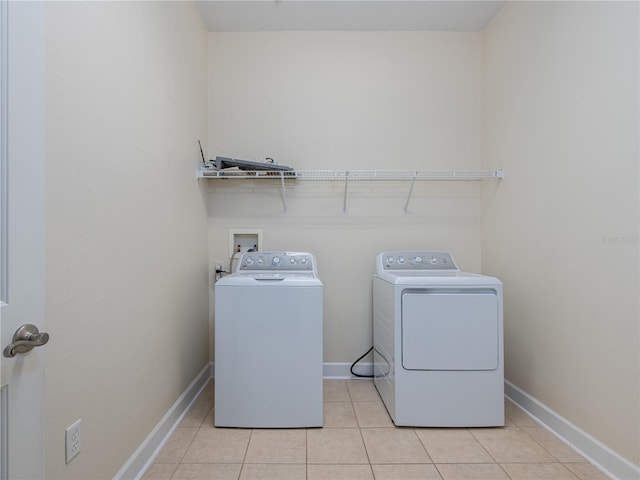 washroom featuring light tile patterned flooring and independent washer and dryer