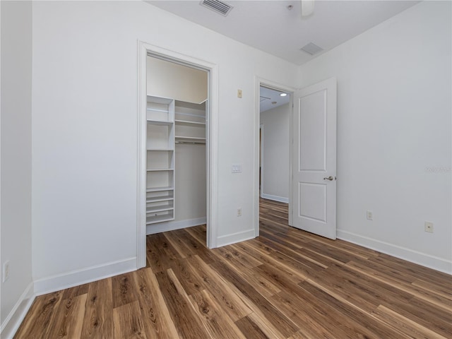 unfurnished bedroom featuring dark wood-type flooring and a closet