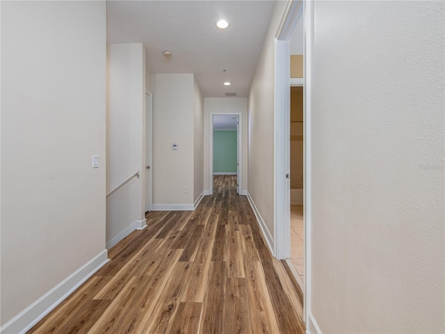 corridor with dark hardwood / wood-style flooring