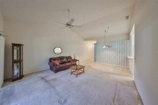 living room with vaulted ceiling, light colored carpet, and ceiling fan