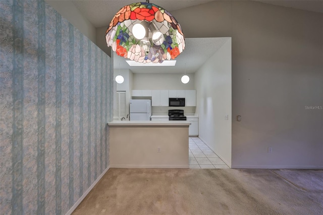 kitchen featuring white cabinetry, a skylight, kitchen peninsula, light colored carpet, and black appliances