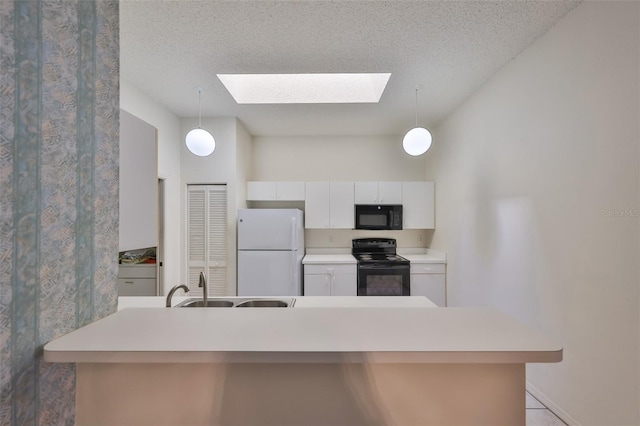 kitchen with white cabinets, hanging light fixtures, a textured ceiling, and black appliances