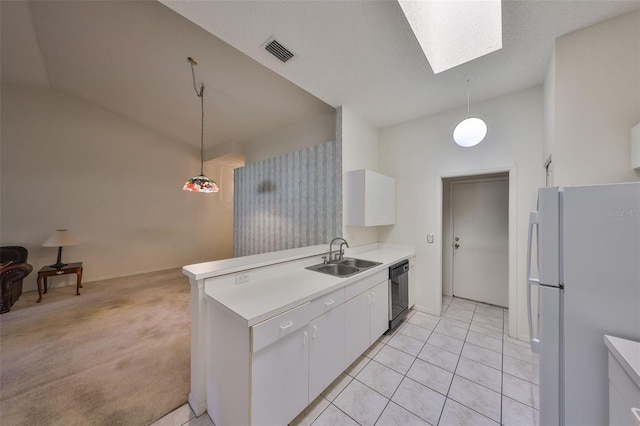 kitchen with pendant lighting, sink, dishwashing machine, white refrigerator, and white cabinets