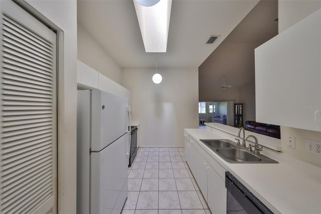 kitchen featuring white cabinetry, sink, a skylight, and black appliances