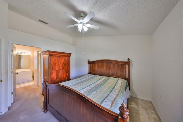 carpeted bedroom with vaulted ceiling, connected bathroom, a textured ceiling, and ceiling fan