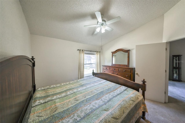 bedroom featuring lofted ceiling, carpet flooring, a textured ceiling, and ceiling fan