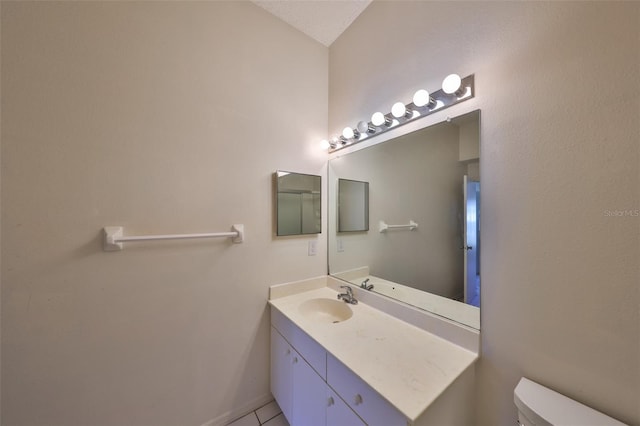 bathroom featuring vanity, toilet, and tile patterned flooring