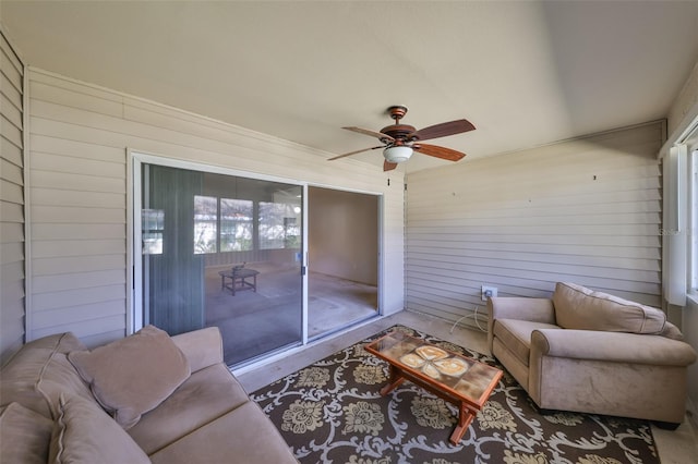 sunroom / solarium featuring ceiling fan