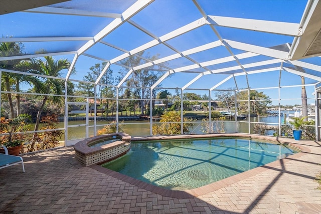 view of swimming pool with a patio, a water view, an in ground hot tub, and glass enclosure