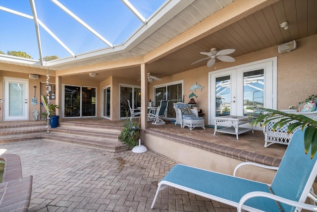 view of patio / terrace featuring a lanai, ceiling fan, and french doors