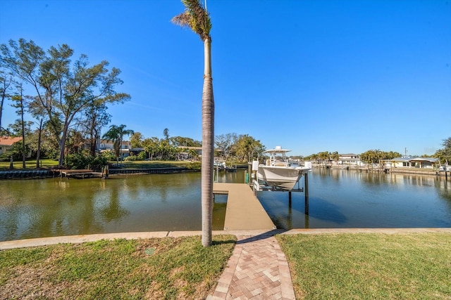 dock area featuring a yard and a water view