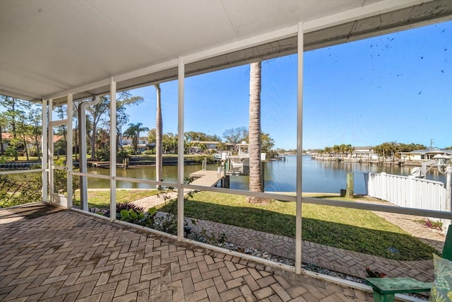 unfurnished sunroom with a healthy amount of sunlight and a water view