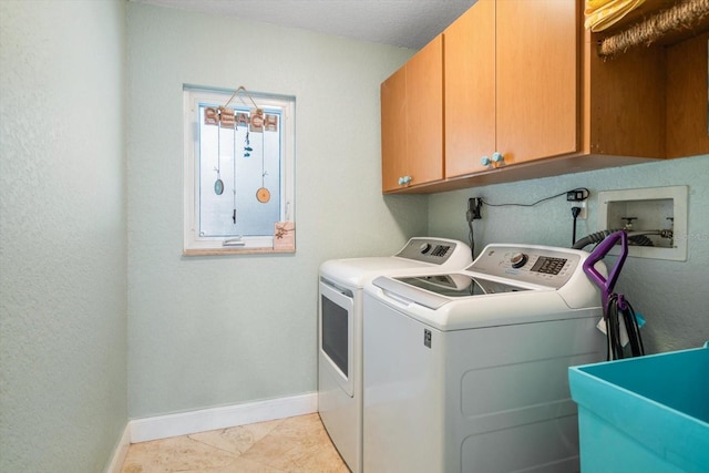 laundry area with cabinets, washing machine and dryer, and sink