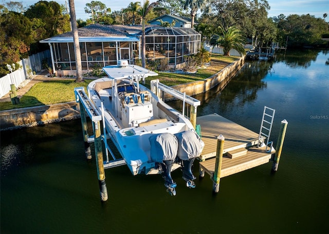 dock area with a water view, a yard, and a lanai