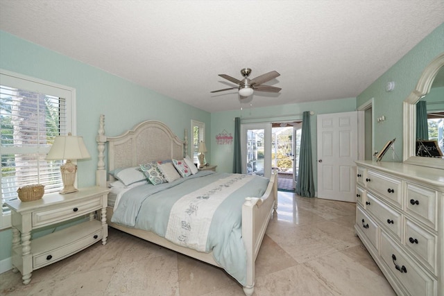 bedroom with access to exterior, a textured ceiling, and ceiling fan