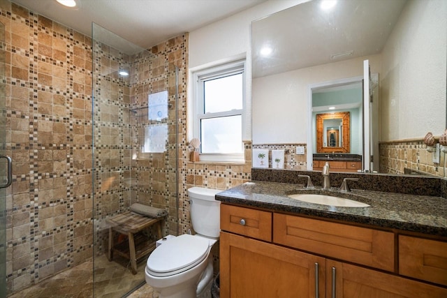 bathroom featuring vanity, tile walls, an enclosed shower, and toilet