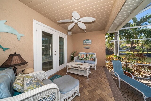 sunroom / solarium with french doors, ceiling fan, and wood ceiling