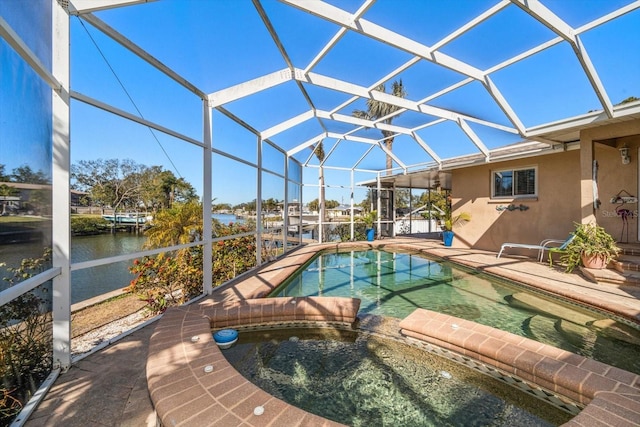 view of swimming pool with a water view, an in ground hot tub, a lanai, and a patio area