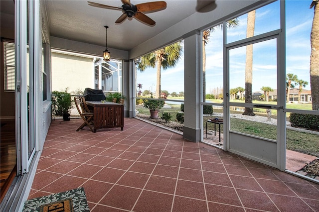 sunroom featuring ceiling fan