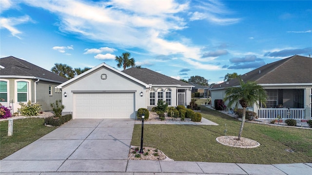 single story home featuring a garage, a front yard, and covered porch