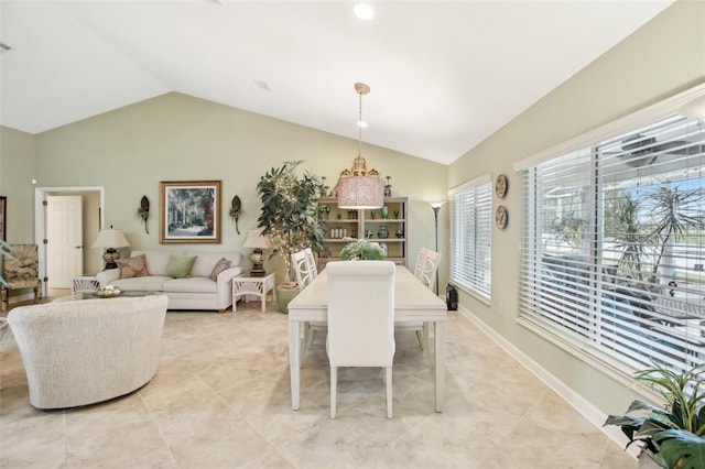 dining area featuring vaulted ceiling