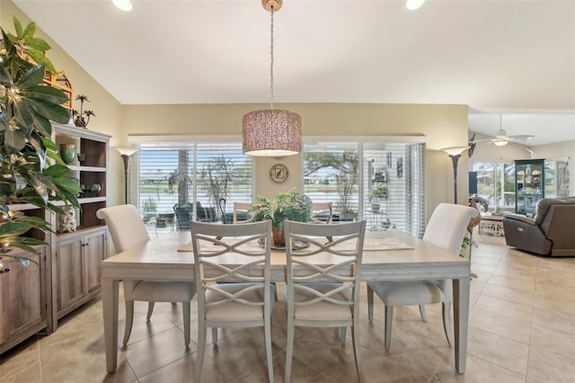 tiled dining space featuring ceiling fan and lofted ceiling