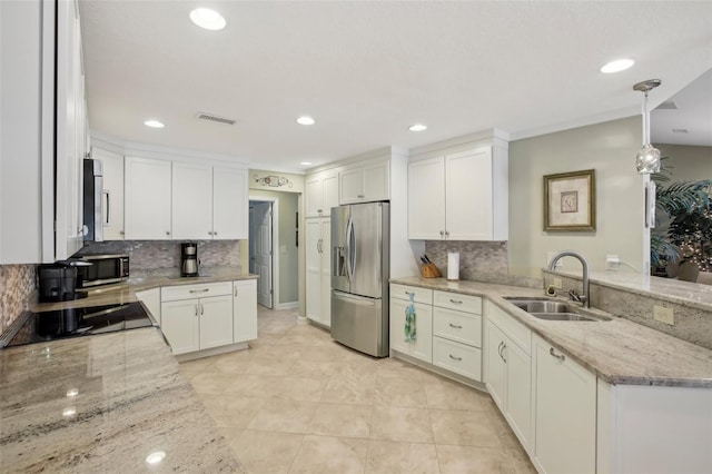 kitchen with sink, light stone counters, decorative light fixtures, appliances with stainless steel finishes, and white cabinets