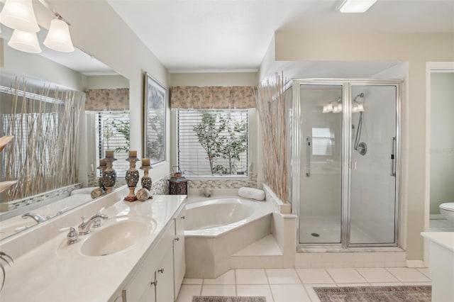 full bathroom featuring independent shower and bath, vanity, tile patterned floors, and toilet