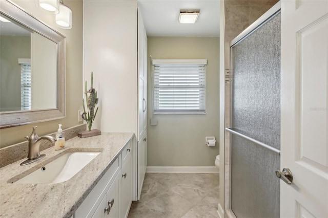 bathroom with tile patterned flooring, vanity, toilet, and a shower with shower door