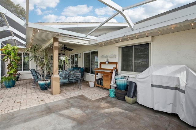 view of patio / terrace featuring ceiling fan and a lanai