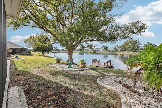 view of yard featuring a boat dock and a water view