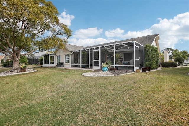 rear view of house with a patio, glass enclosure, and a lawn