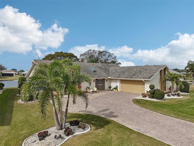 single story home with a garage and a front yard