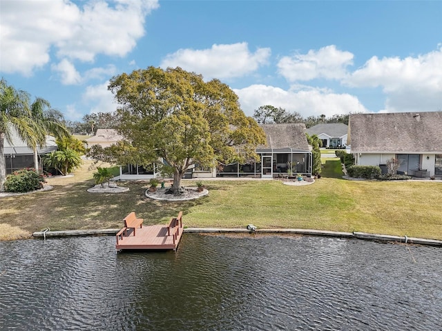 dock area with a water view and a lawn