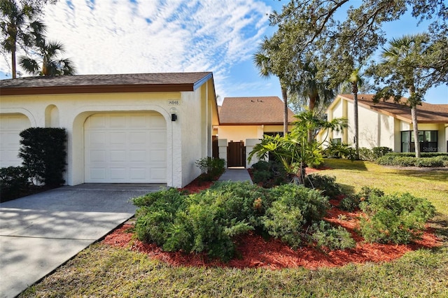 view of front of home with a garage and a front lawn