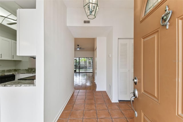 foyer featuring ceiling fan and light tile patterned floors