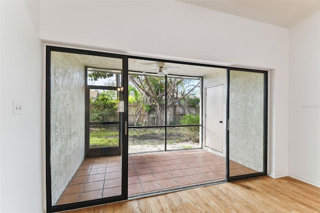 doorway to outside with ceiling fan and hardwood / wood-style floors