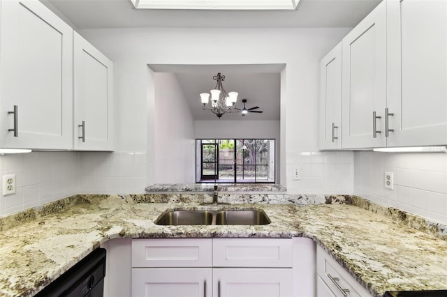 kitchen featuring sink, hanging light fixtures, dishwasher, white cabinets, and backsplash