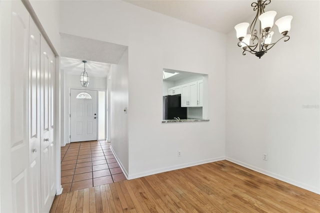 entrance foyer featuring a chandelier and light wood-type flooring