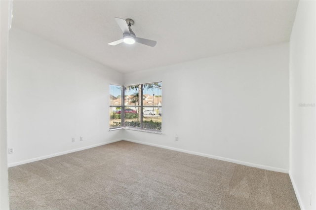 carpeted empty room featuring ceiling fan