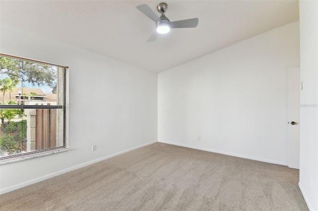 spare room with light colored carpet and ceiling fan