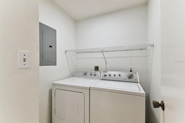 clothes washing area featuring independent washer and dryer and electric panel