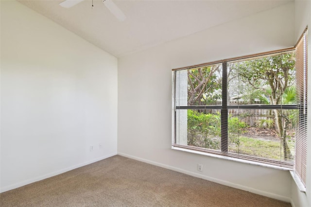 carpeted empty room with vaulted ceiling and ceiling fan