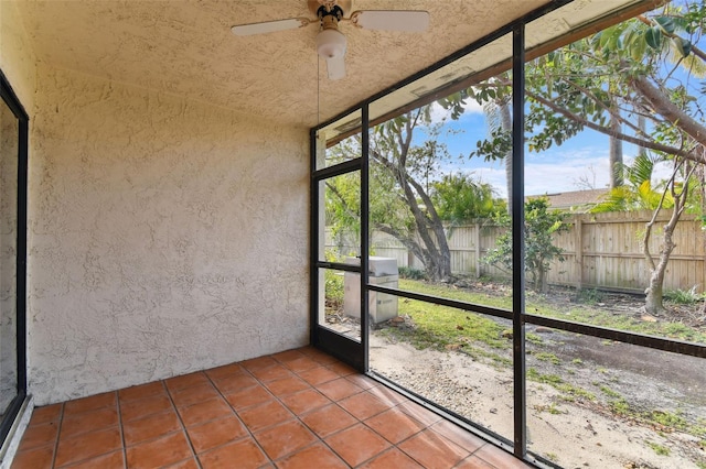 unfurnished sunroom with ceiling fan