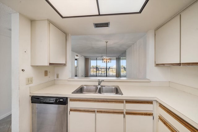 kitchen featuring pendant lighting, sink, white cabinets, stainless steel dishwasher, and a chandelier