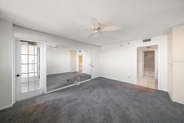 carpeted empty room with a textured ceiling and ceiling fan