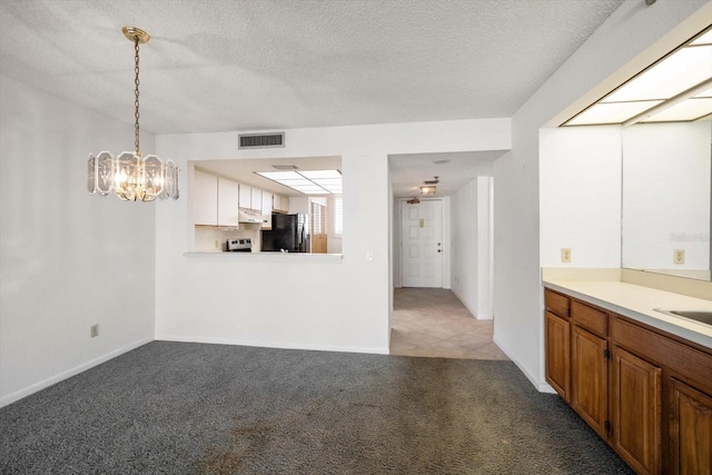 interior space featuring light carpet, sink, a chandelier, and a textured ceiling